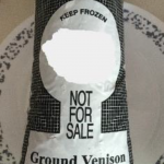 A close-up photo of a package of ground venison on a plate. 