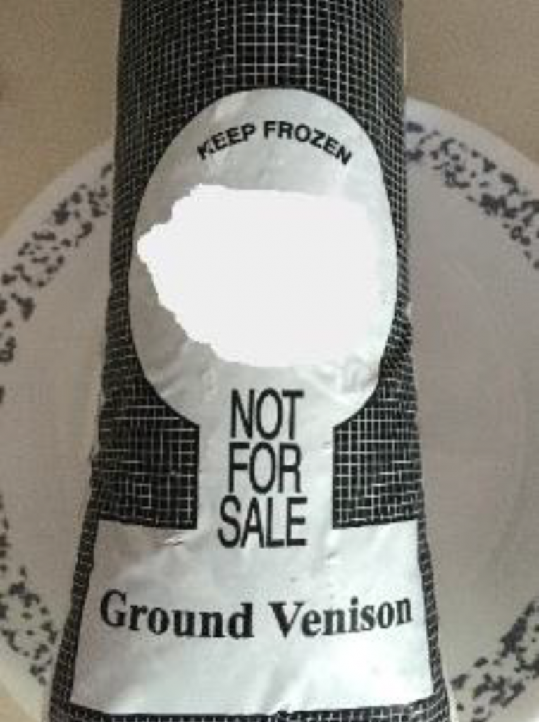 A close-up photo of a package of ground venison on a plate.